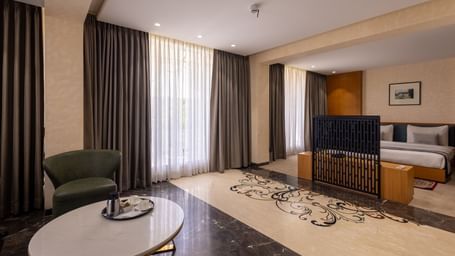 Combined view or the bedroom parted from the living area by a TV in the Suite of Pravasa Stay Vijay Nagar, Indore.
