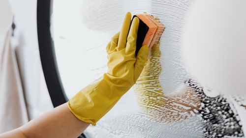 person cleaning with a sponge