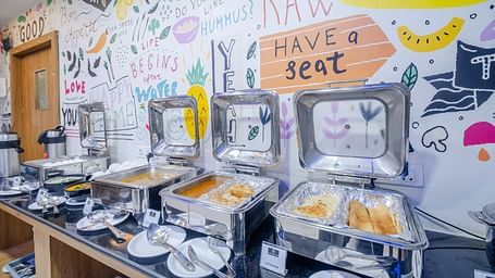 Dining area featuring buffet options and artistic wall decor at Lemonridge Hotels