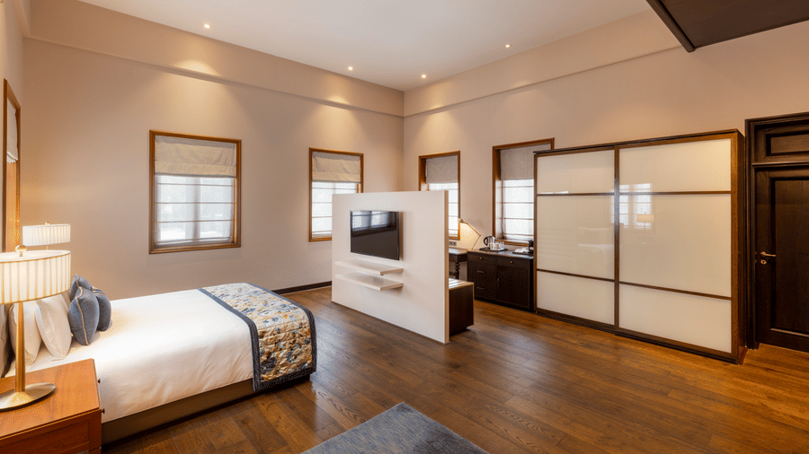 Premium Club Room with a bed and sliding wardrobe doors at Kenilworth Hotel, Kolkata.