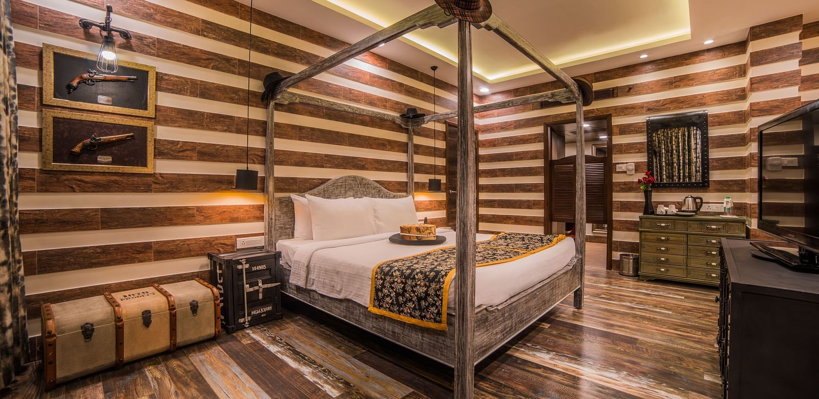  A stylish hotel room featuring a four-poster bed and striped walls in a warm, neutral palette A grand hotel suite with an opulent red and white decor, large bed, and seating area, reflecting a traditional style at Sitara Luxury Hotel in Hyderabad near Ram