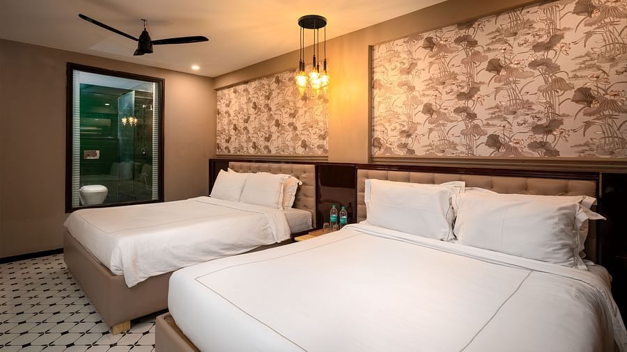 A beautifully designed room with a comfortable bed, soft lighting, and contemporary furnishings at Crescent Resort, Goa