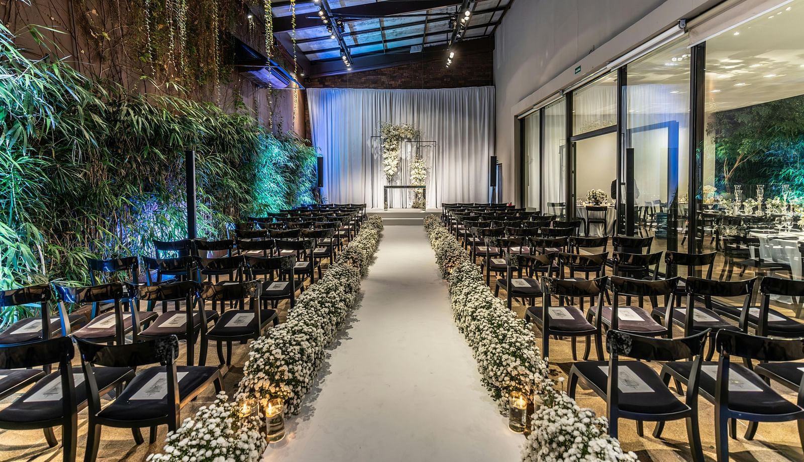 An image of a banquet hall with seating arrangement and floral decoration