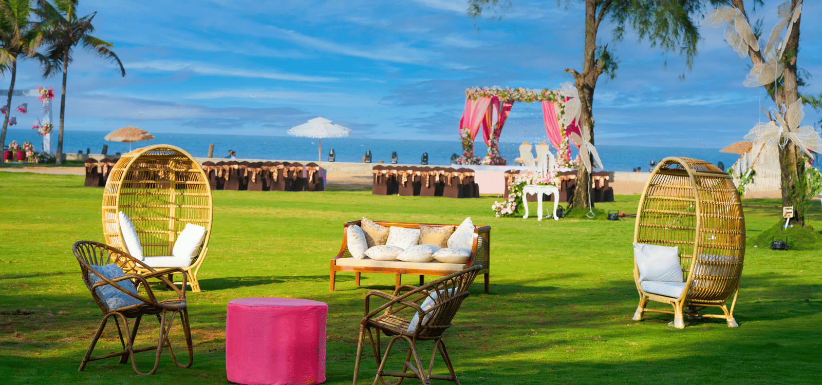 A cosy outdoor lounge seating arranged on the lawn overlooking a beachfront wedding mandap in Mahabalipuram - Grande Bay Resort & Spa, Mamallapuram