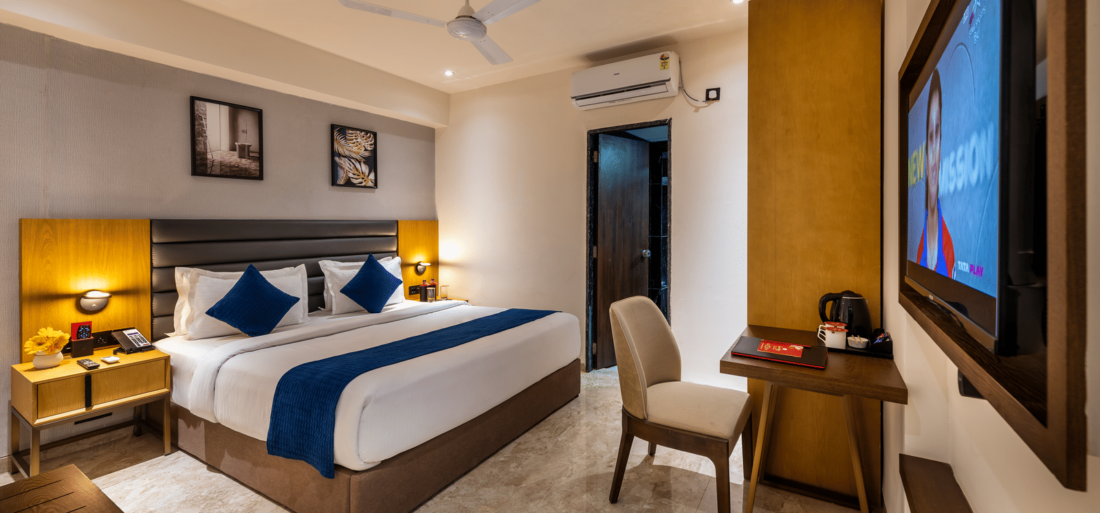 Elegant reception area with decorative wall art and welcoming front desk at Lords Studio Inn, Jamnagar.