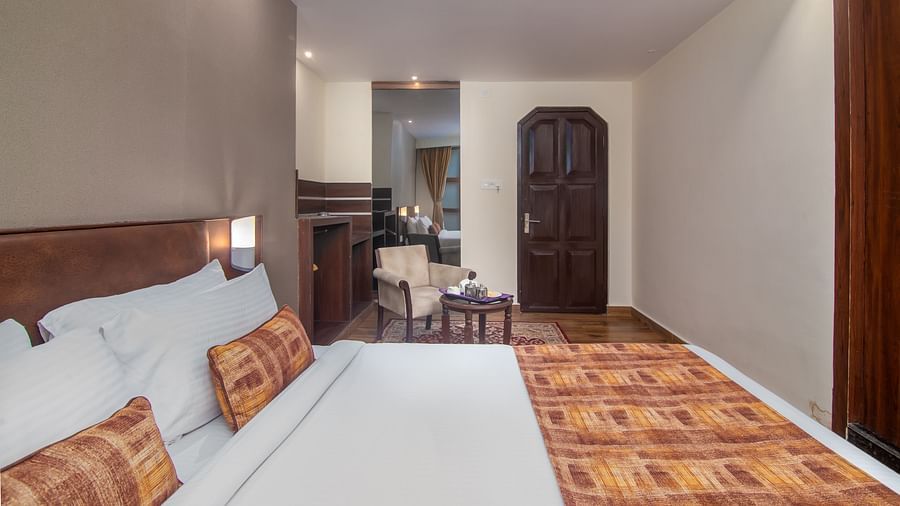 A double bed with plush bedding in the Deluxe Double room at Hotel Sumitel Vista T.V Tower