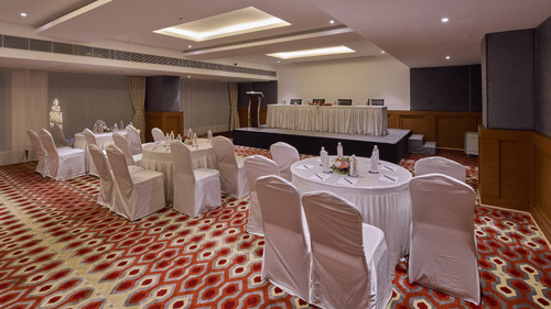 chairs with white cloths set up in a cluster arrangement in Mandapa, the ballroom at Grand Continent, Mahabalipuram