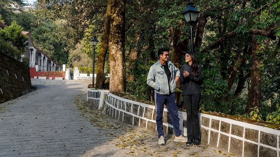 a couple having a conversation with a forest in the background
