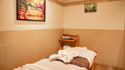 A peaceful spa treatment room with a massage bed, soothing decor, and essential oils - Balaji Sarovar Premiere, Solapur