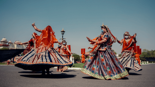 women in traditional Rajasthani attire dancing at a festival
