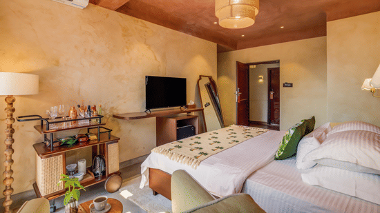 Inviting bedroom at Unseen Boutique Hotel with warm tones, modern furnishings, and a cozy atmosphere designed for comfort and style.