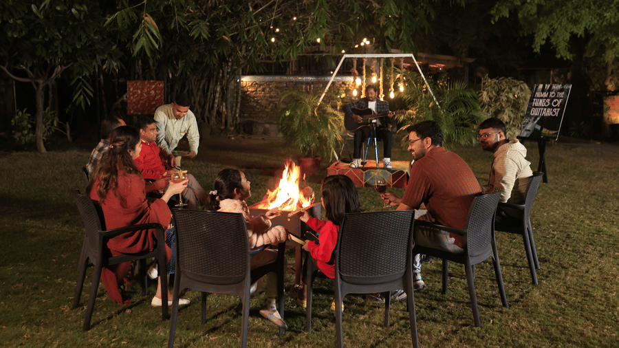 A group of poeple enjoying a bonfire evening outdoors at The Golden Tusk, Jim Corbett.