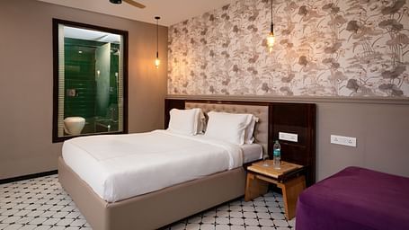 A portrait image showing a well-furnished room with contemporary décor and comfortable furnishings at Crescent Resort, Goa