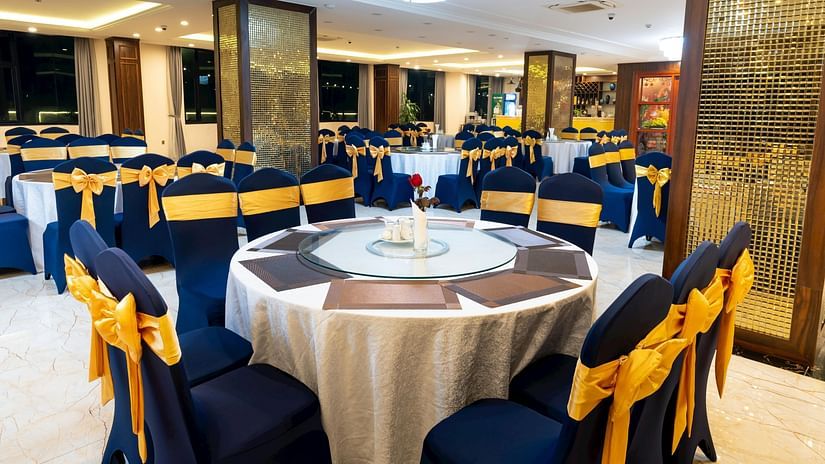 An image of a banquet hall with round tables, and chairs