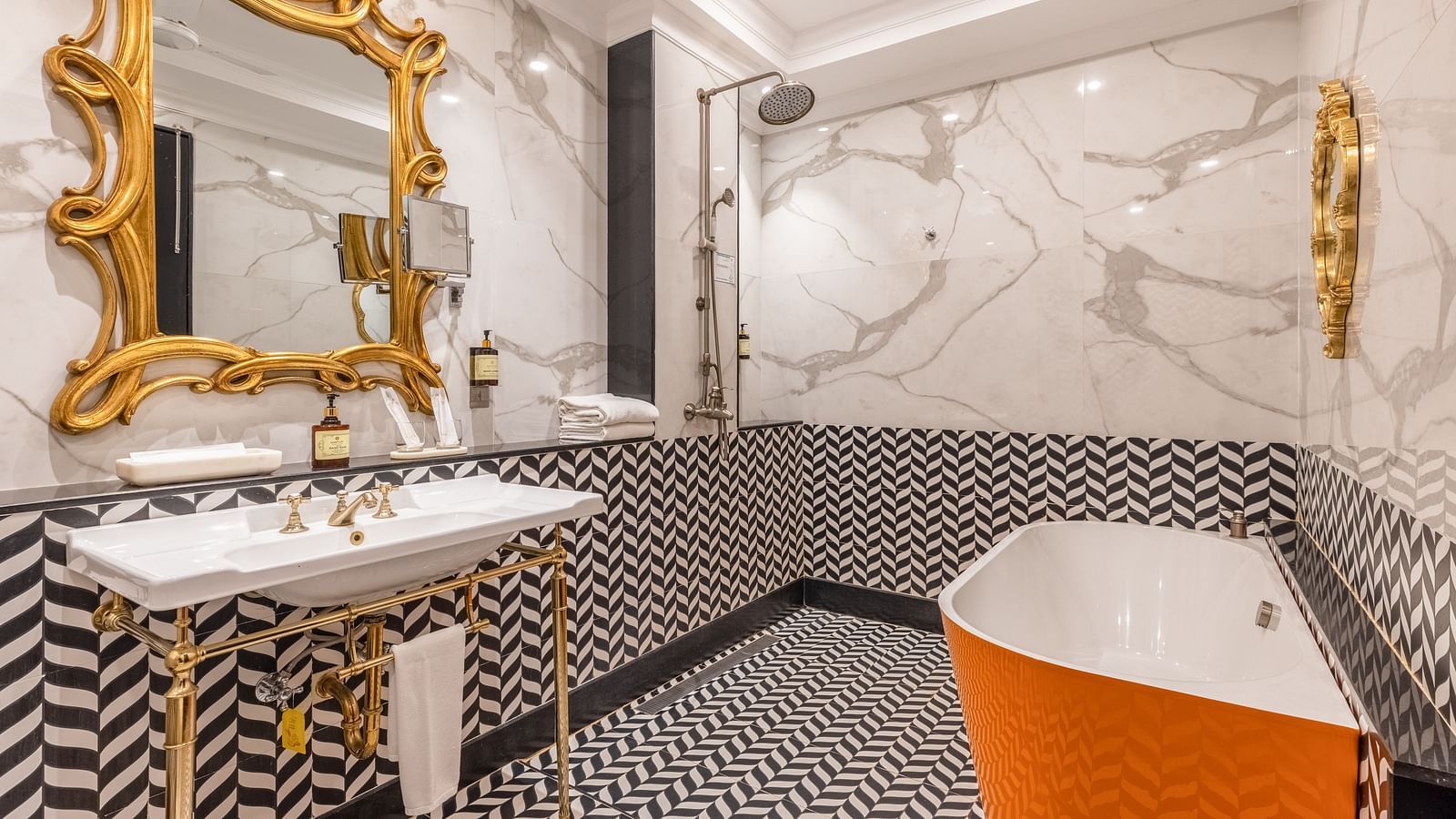 Luxurious bathroom with freestanding tub and golden mirror at MAYFAIR Palm Beach Resort, Gopalpur-on-Sea