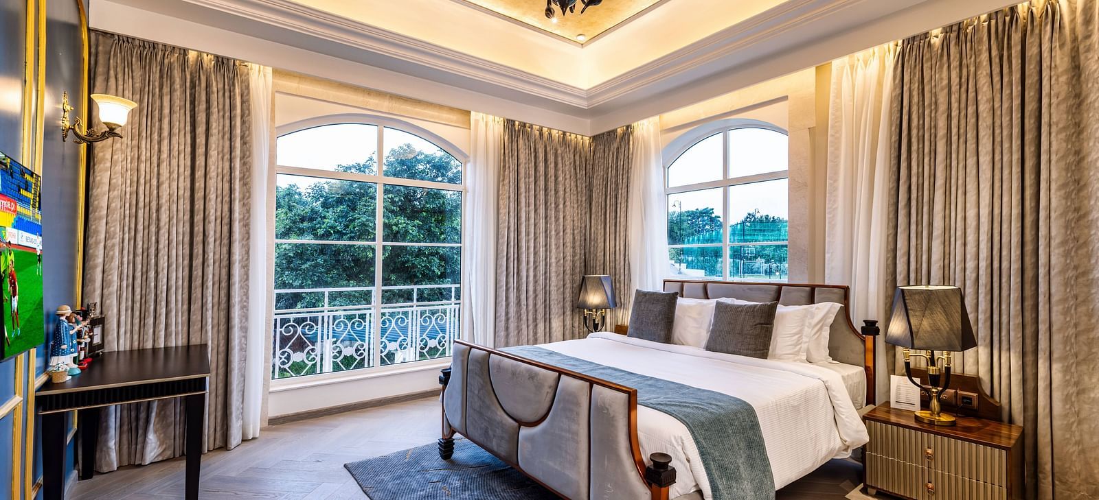 Full view shot of the bedroom of the Suite with ample natural light coming from the windows at Imperial Goa.