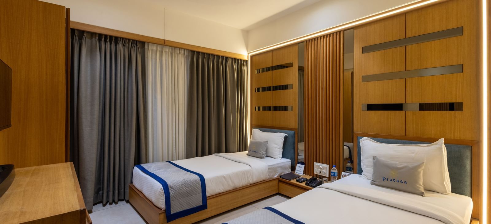 Side view of twin beds in the Superior Room of Pravasa Stay Vijay Nagar, Indore.
