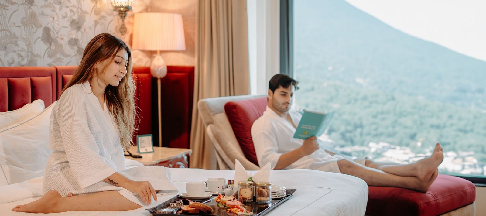 A couple enjoying in-room dining while relaxing on the furniture at Crescent Spa & Resort, Indore