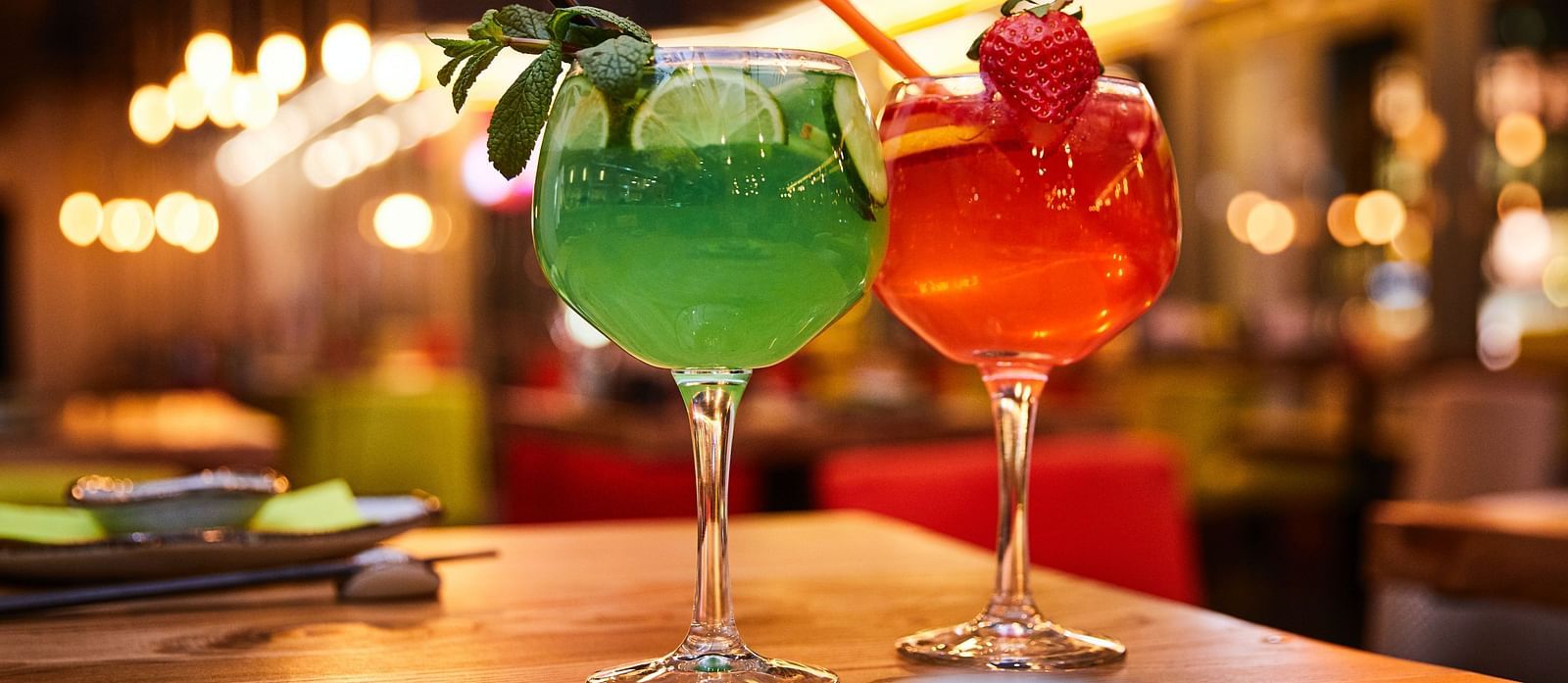  Two cocktails positioned close together on the table, captured in a close-up view
