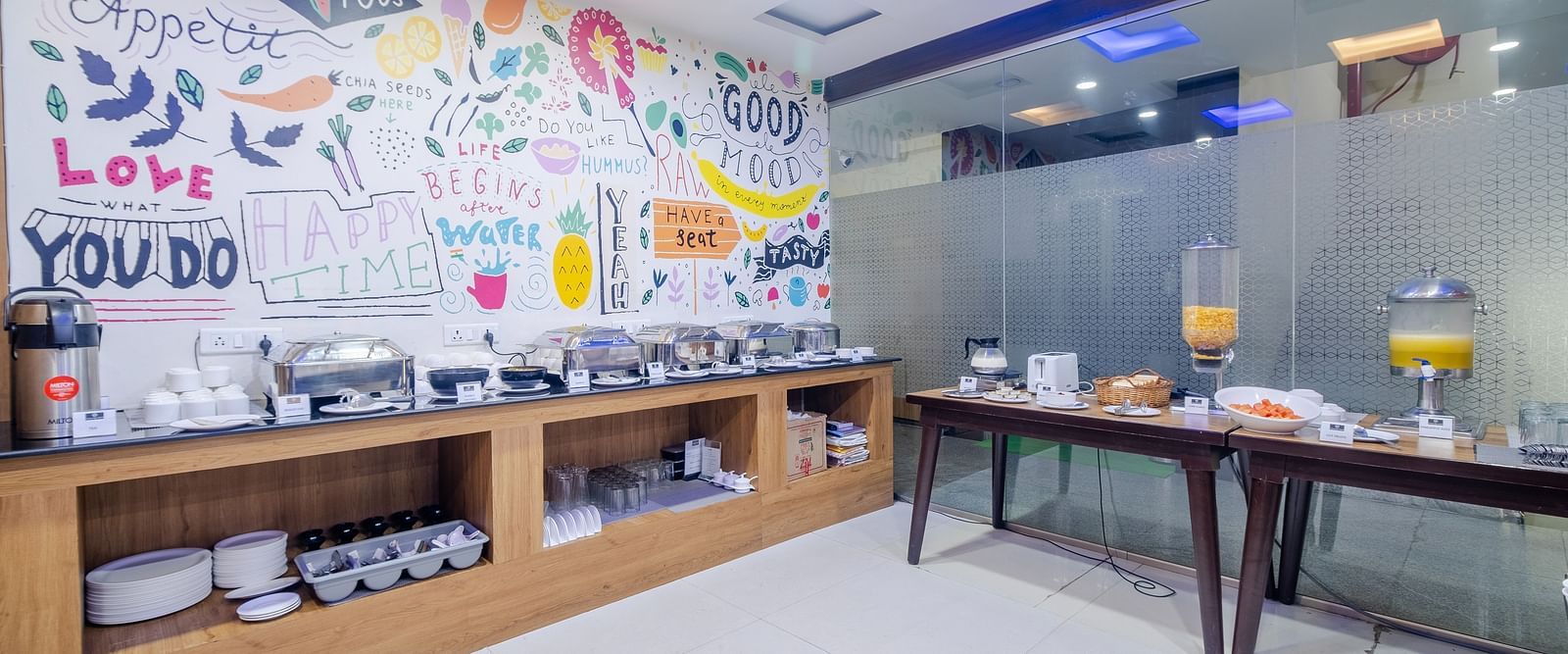 Dining area featuring buffet options and artistic wall decor at Lemonridge Hotels