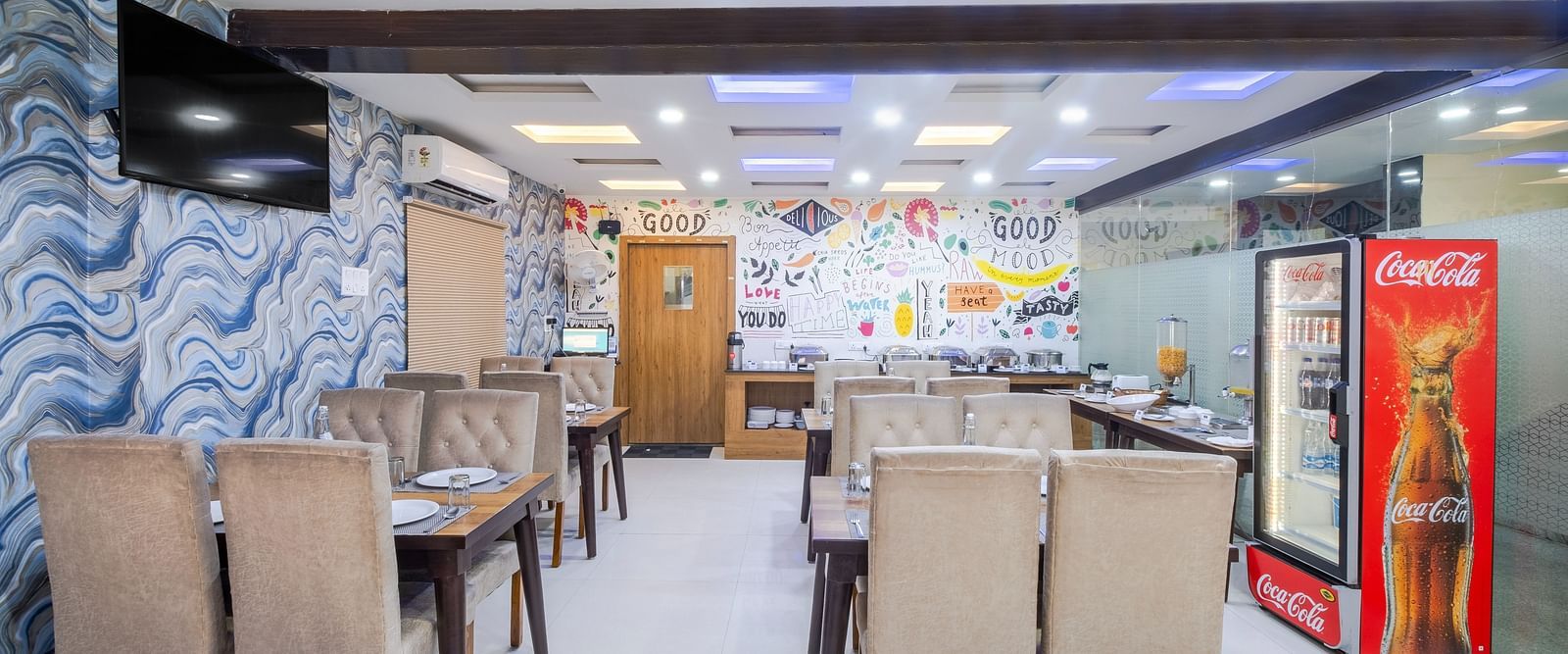 Dining tables arranged with beverage cooler at Lemonridge Hotels restaurant