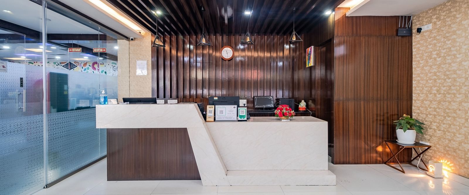 Reception front view with a wood-decorated ceiling and lights at Lemonridge Hotels