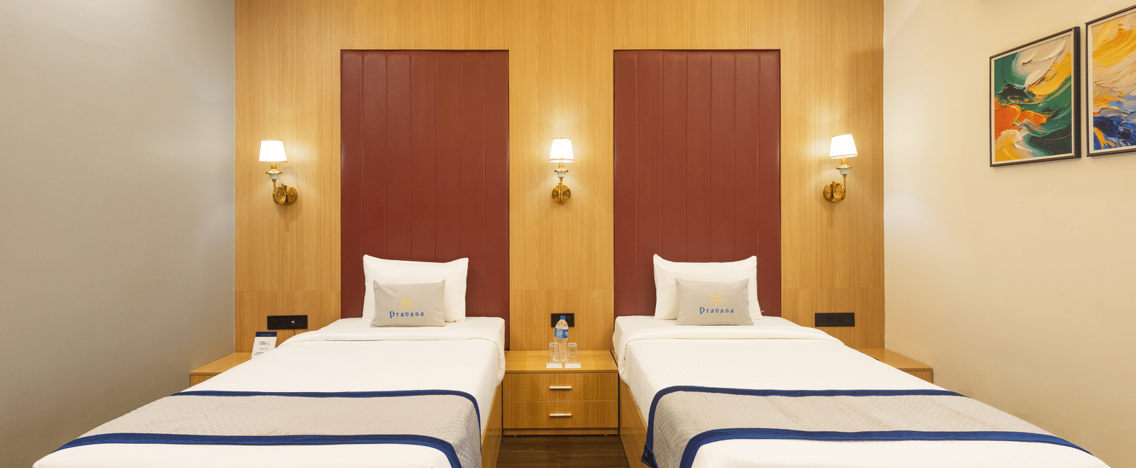 Interior view of a guest room showing 2 single beds with 2 headboard at Pravasa Stay Luv Kush, Indore.