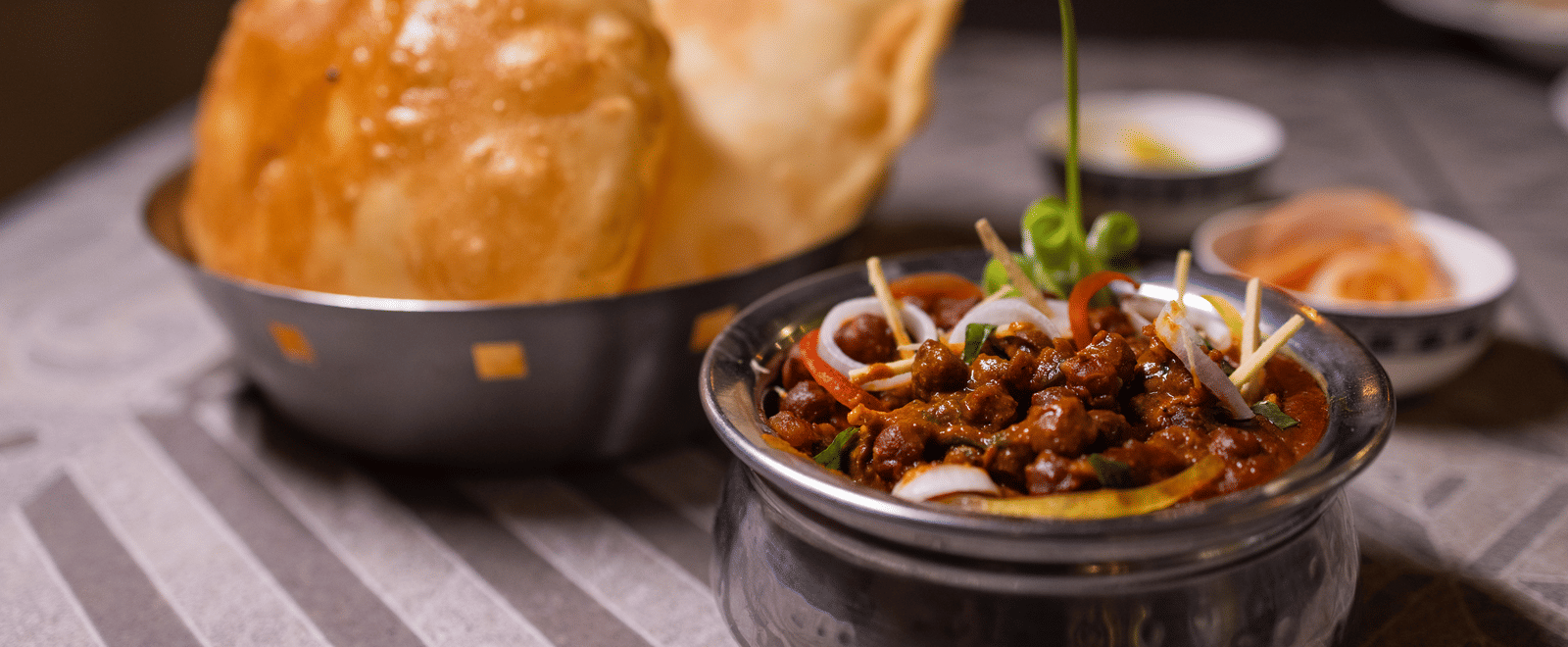 View of Indian fried bread, likely puri with a curry side dish at Pravasa Stay Luv Kush, Indore.