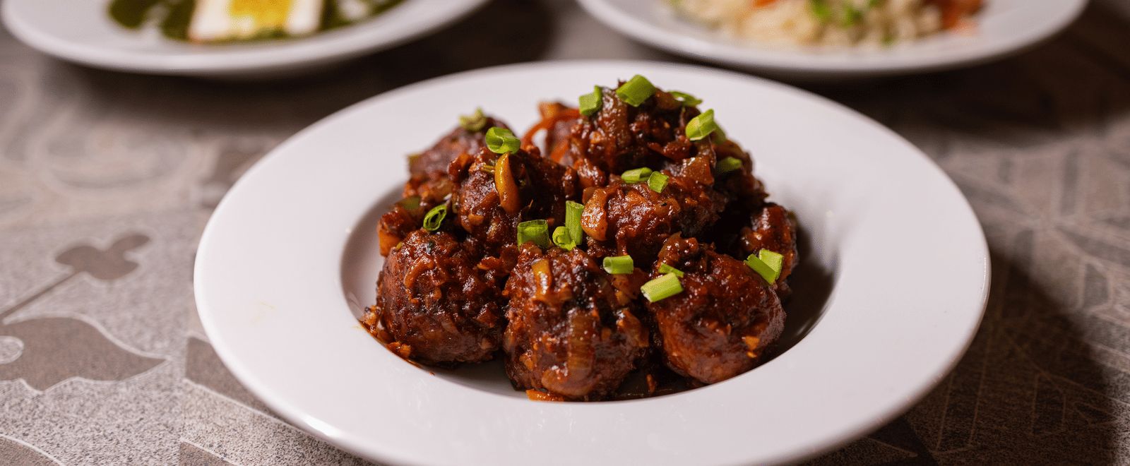 Close-up view of a plate of food, possibly a main course, at Pravasa Stay Luv Kush, Indore.
