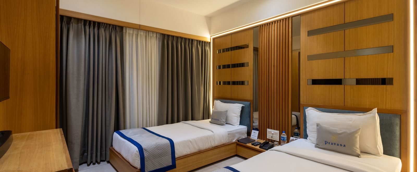 Side view of twin beds in the Superior Room of Pravasa Stay Vijay Nagar, Indore.