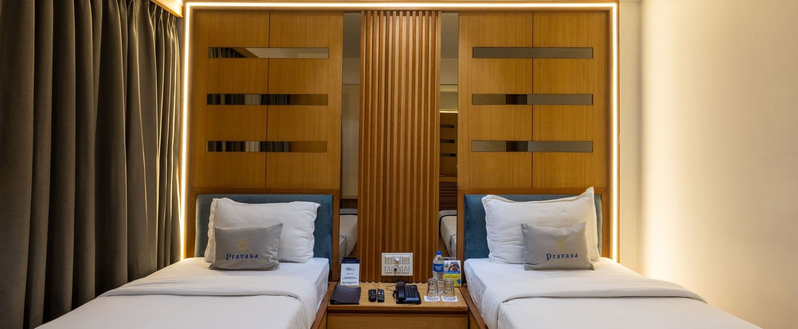 Twin beds highlighted with a central placement in the Superior Room of Pravasa Stay Vijay Nagar, Indore.