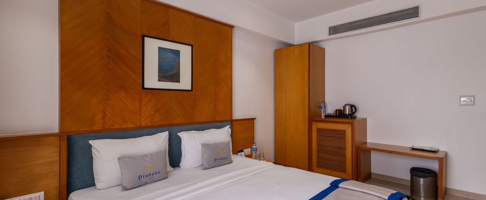 Side view of the queen size bed seen in the Executive Premium Room of Pravasa Stay Vijay Nagar, Indore.