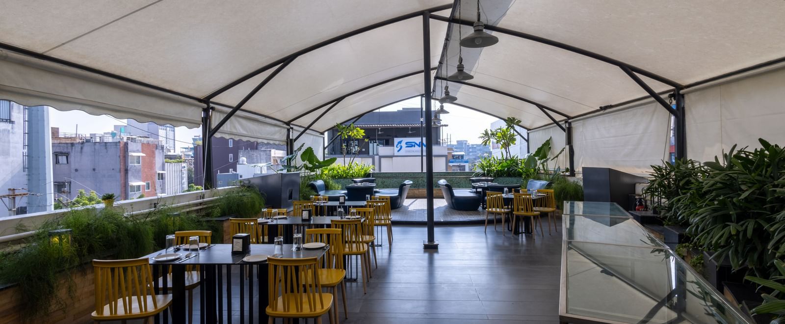 Rooftop dining setup in the Pravasa Cafe at Pravasa Stay Vijay Nagar, Indore.