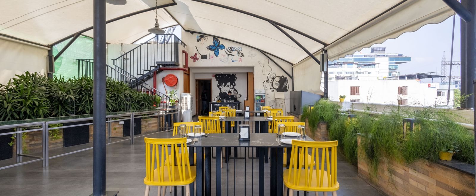 Rooftop dining setup in the Pravasa Cafe at Pravasa Stay Vijay Nagar, Indore.