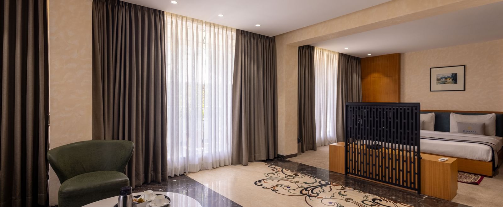 Combined view or the bedroom parted from the living area by a TV in the Suite of Pravasa Stay Vijay Nagar, Indore.