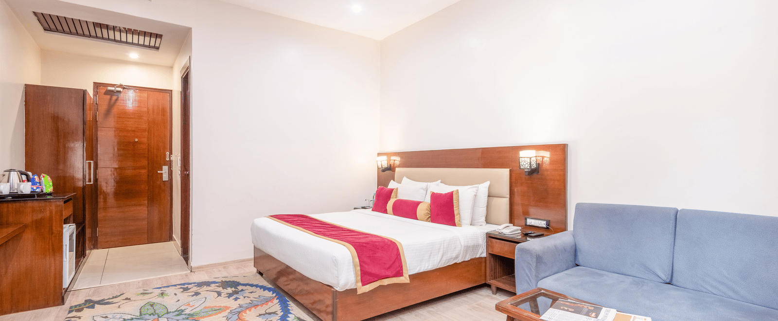 Bedroom with double bed and seating area at DLS Hotels On The Ganges.