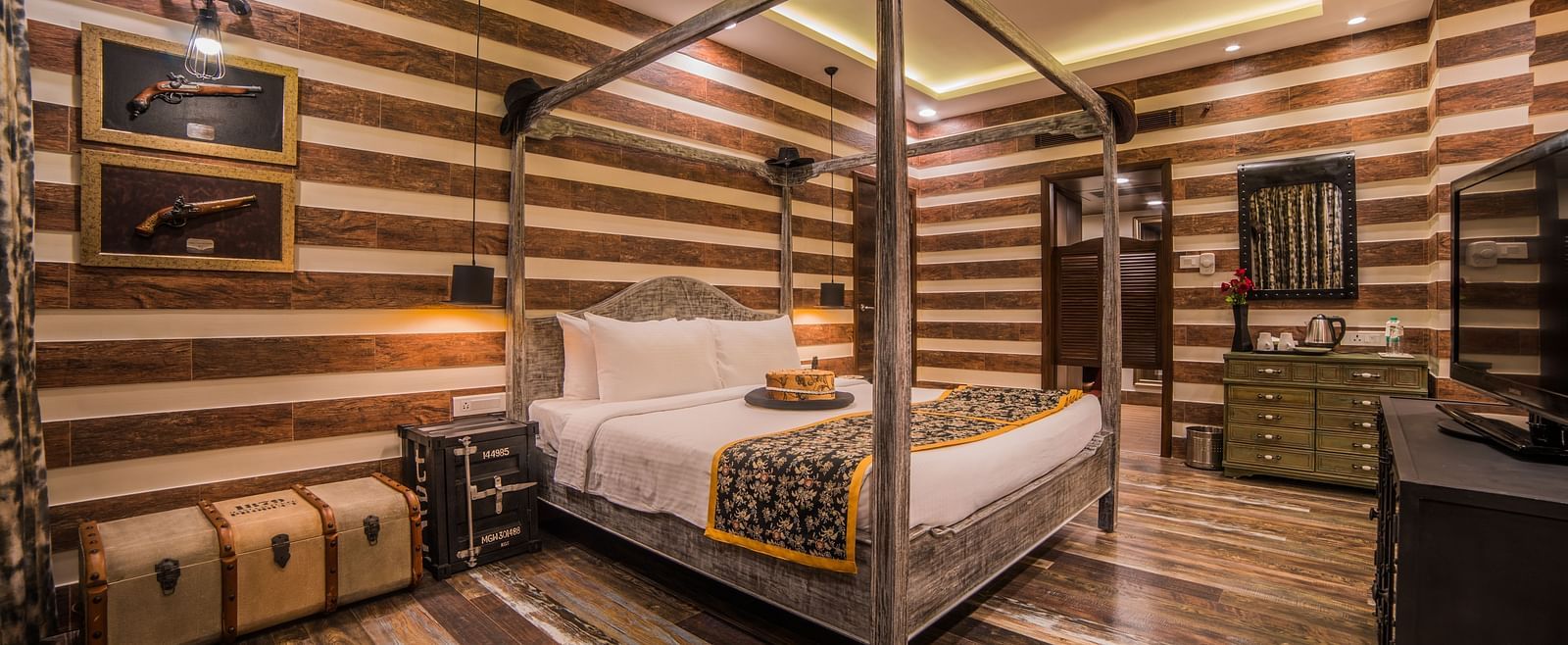  A stylish hotel room featuring a four-poster bed and striped walls in a warm, neutral palette A grand hotel suite with an opulent red and white decor, large bed, and seating area, reflecting a traditional style at Sitara Luxury Hotel in Hyderabad near Ram