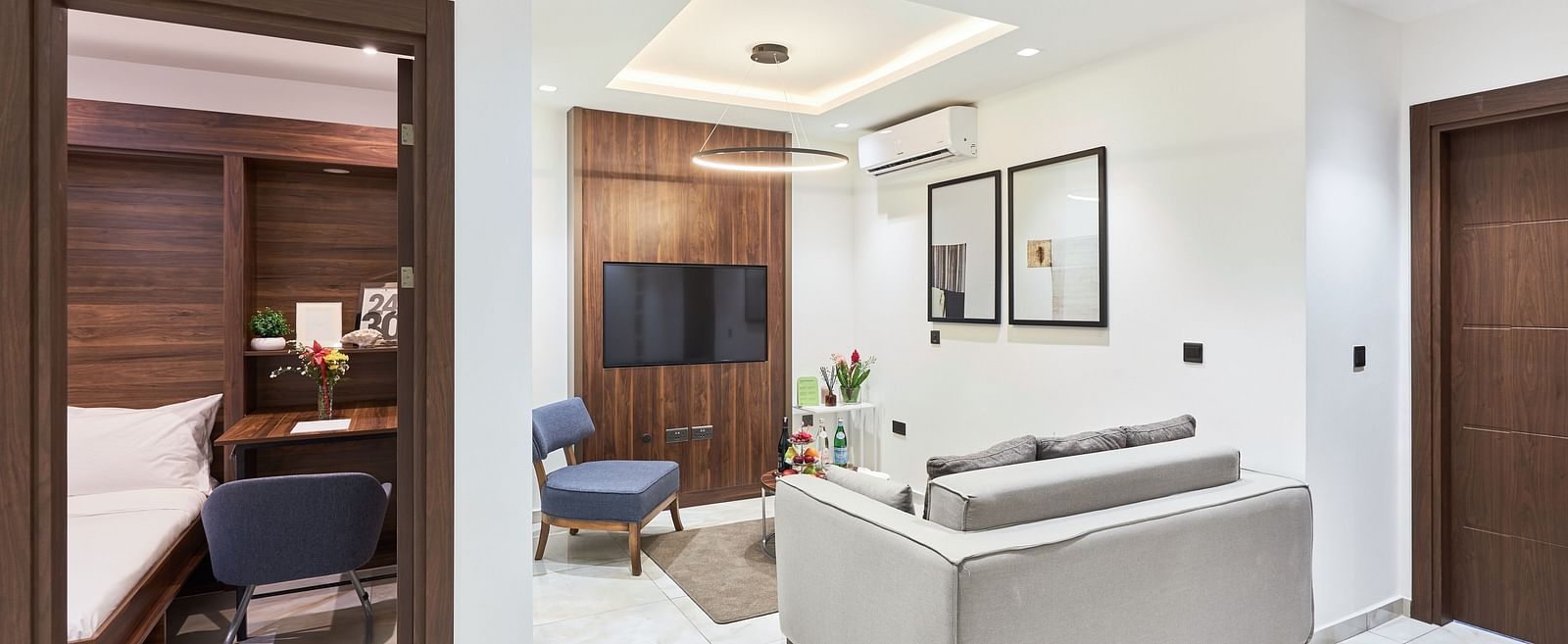 A view of a living area with comfortable seating in front of a television in Executive Suite at The Pelican Hotel, Accra.