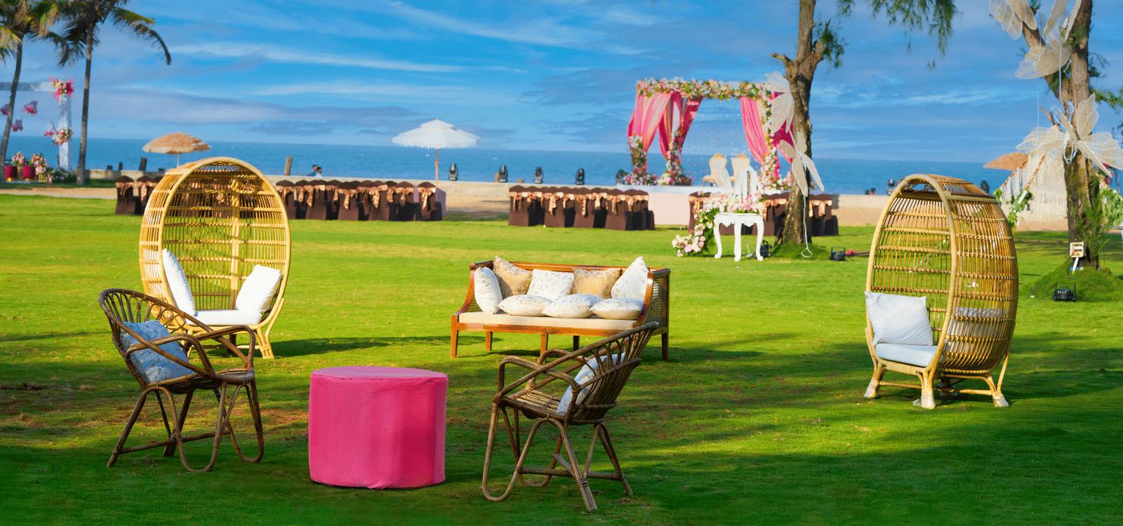 A cosy outdoor lounge seating arranged on the lawn overlooking a beachfront wedding mandap in Mahabalipuram - Grande Bay Resort & Spa, Mamallapuram