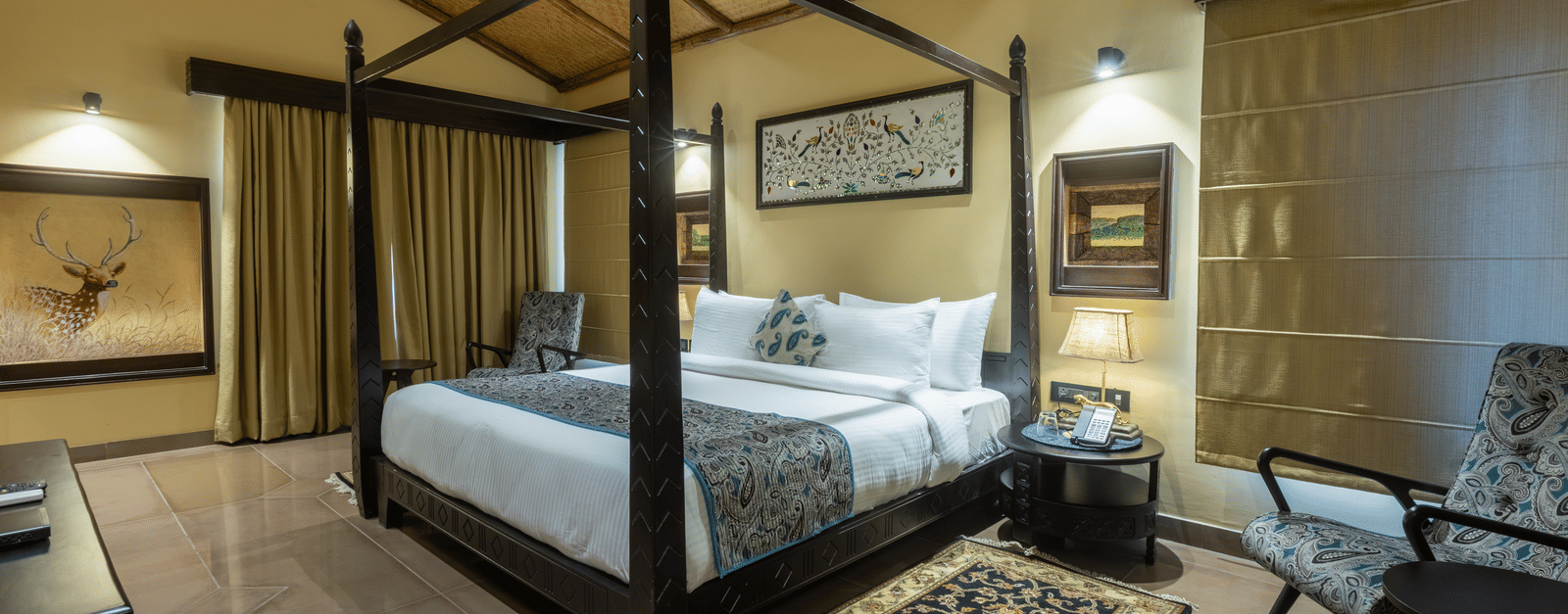 A charming bedroom at Aamaghati Wildlife Resort with refined décor, classic furnishings, and a serene ambience ideal for relaxation.