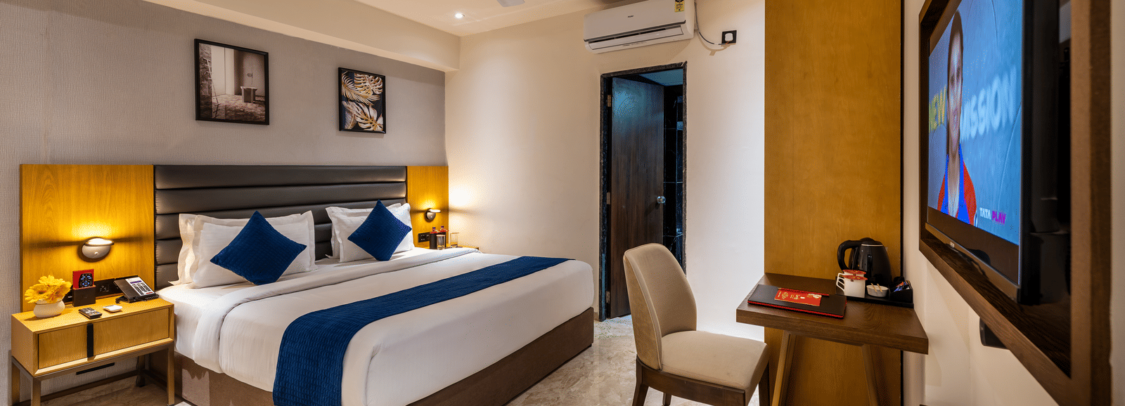 Elegant reception area with decorative wall art and welcoming front desk at Lords Studio Inn, Jamnagar.