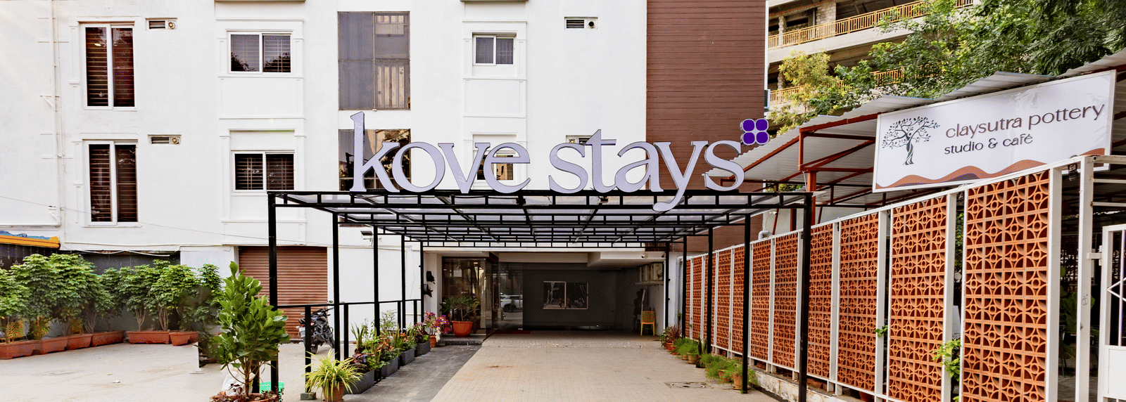 The multi-storey building and entrance with 'Kove stays' sign over a covered walkway leading to the main door of Kove Smart Stays.