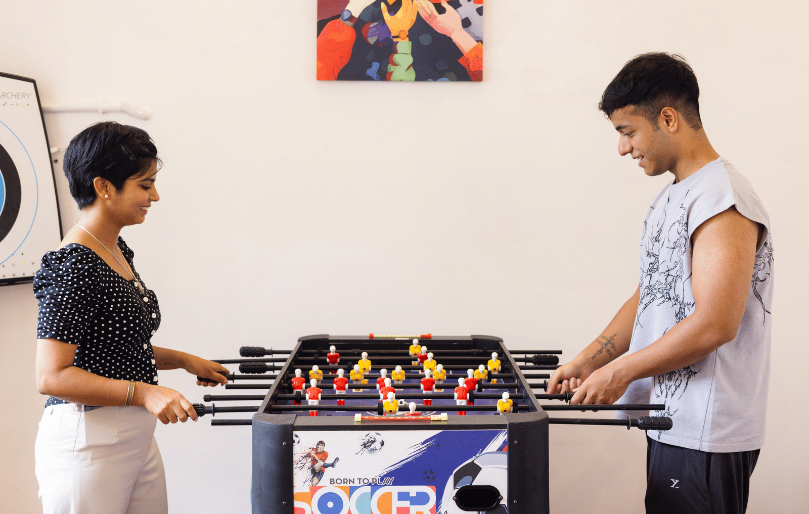 Two people playing table football indoors at Megha Resort & Villas, Dehradun.