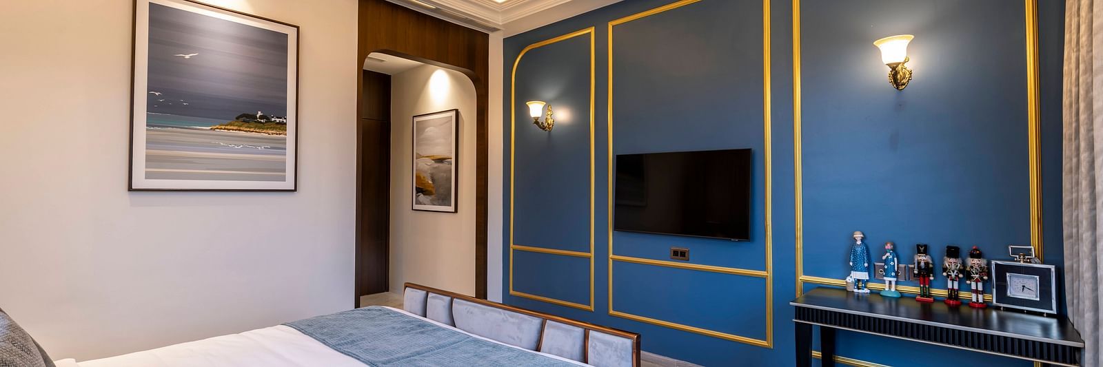 Corner view angle of the bedroom of the Suite with a double bed along with a false ceiling above it at Imperial Goa.