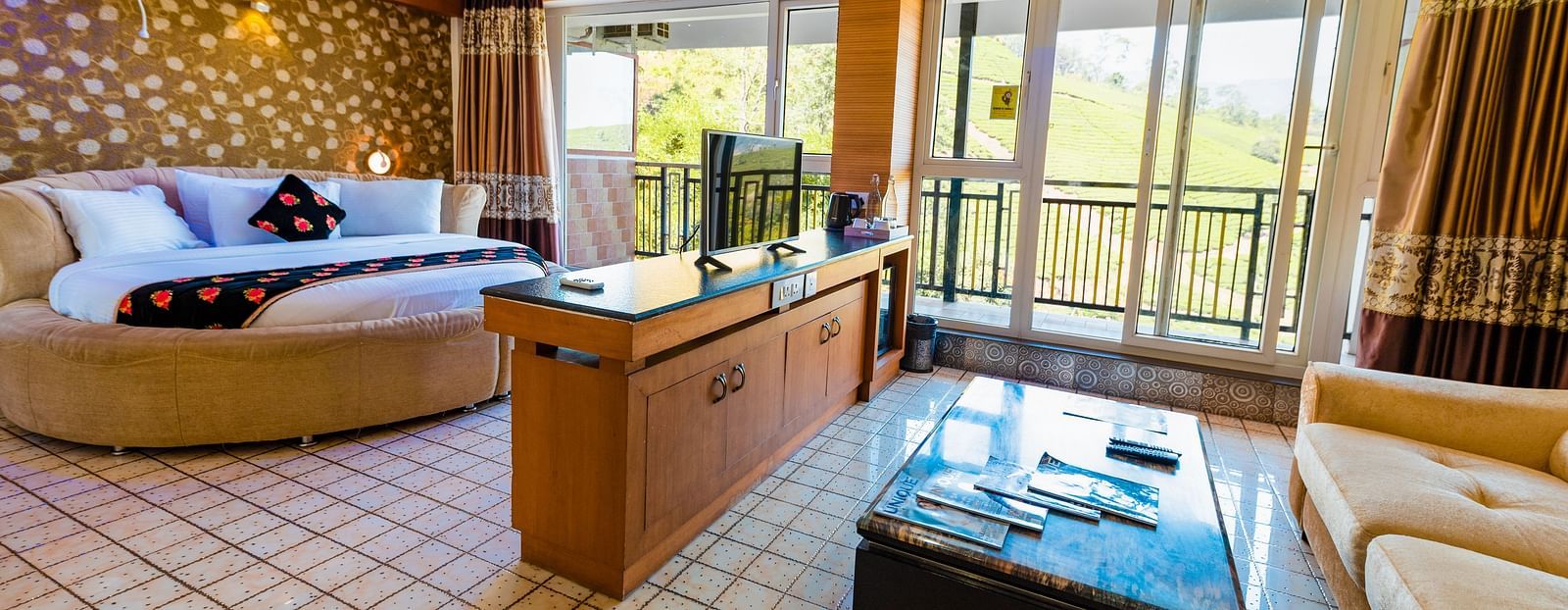 A round bed and a table at Honeymoon Suite at Parakkat Nature Hotel and Resorts Munnar