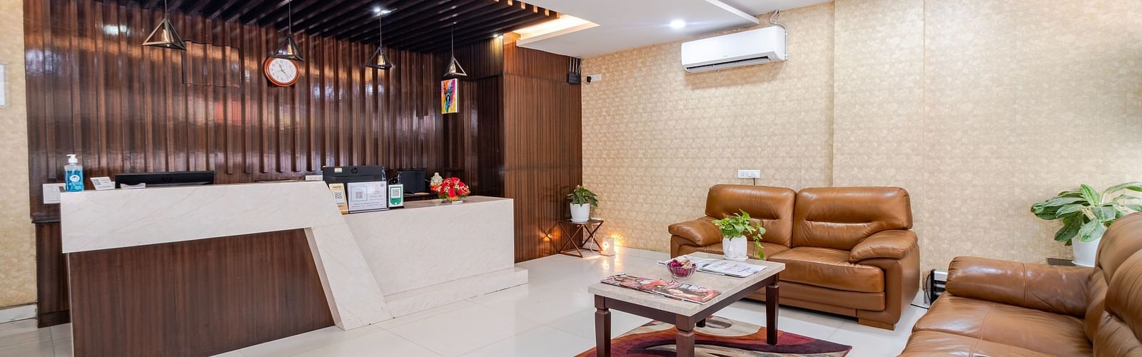 Reception view with sofa seating and AC unit at Lemonridge Hotels