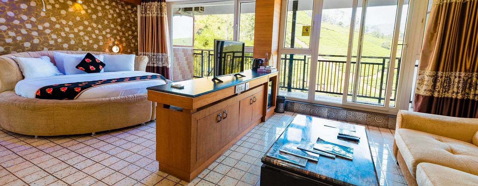 A round bed and a table at Honeymoon Suite at Parakkat Nature Hotel and Resorts Munnar