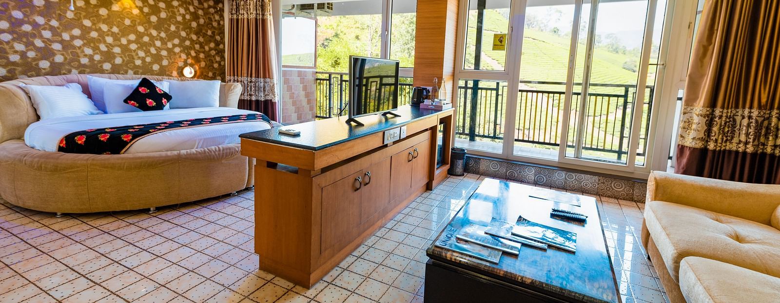 A round bed and a table at Honeymoon Suite at Parakkat Nature Hotel and Resorts Munnar