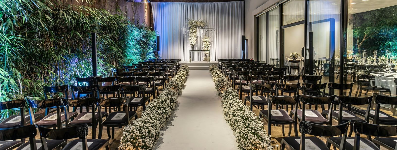 An image of a banquet hall with seating arrangement and floral decoration