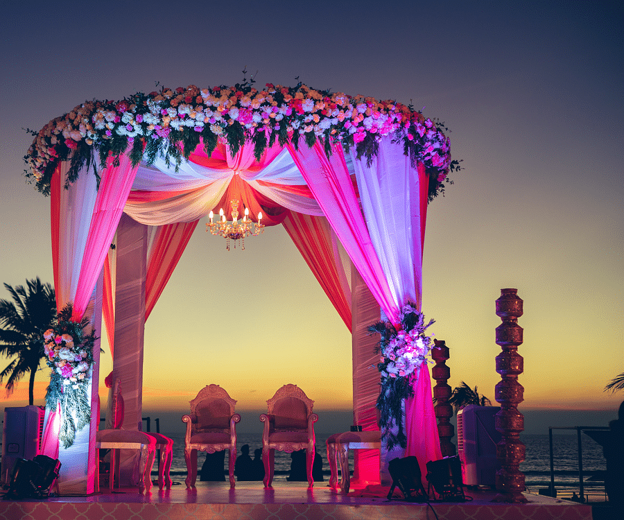 alt-text View of Palm Lawn with lights on during sunset for finest wedding venues in south goa